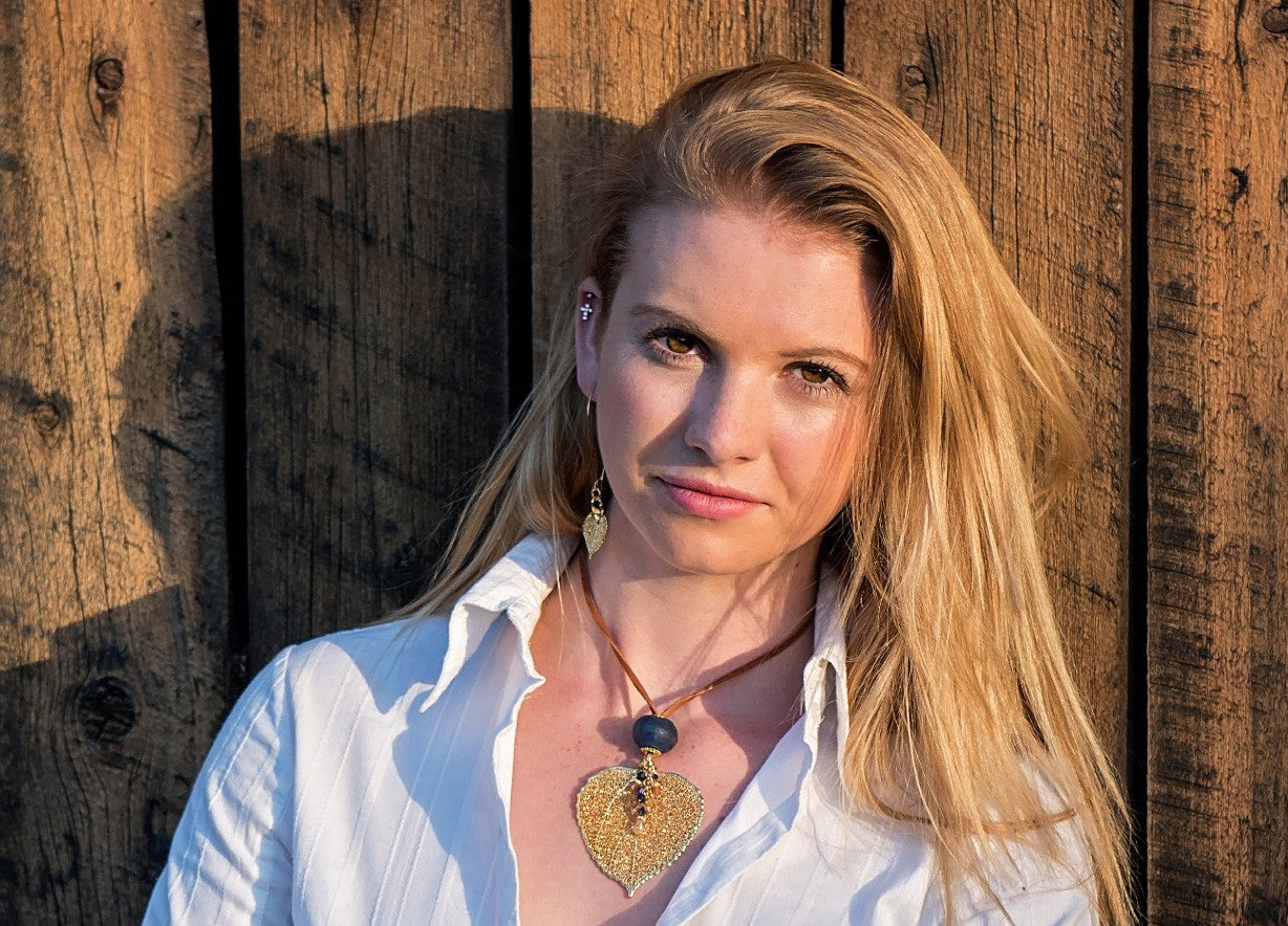 Single re-cycled African glass bead with a large copper Aspen leaf finished with a stunning crystal dangle. Deerskin leather