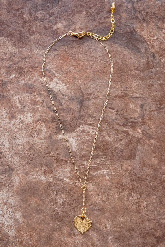 Classic Gold chain creates this dramatic Y style necklace with a small Gold leaf