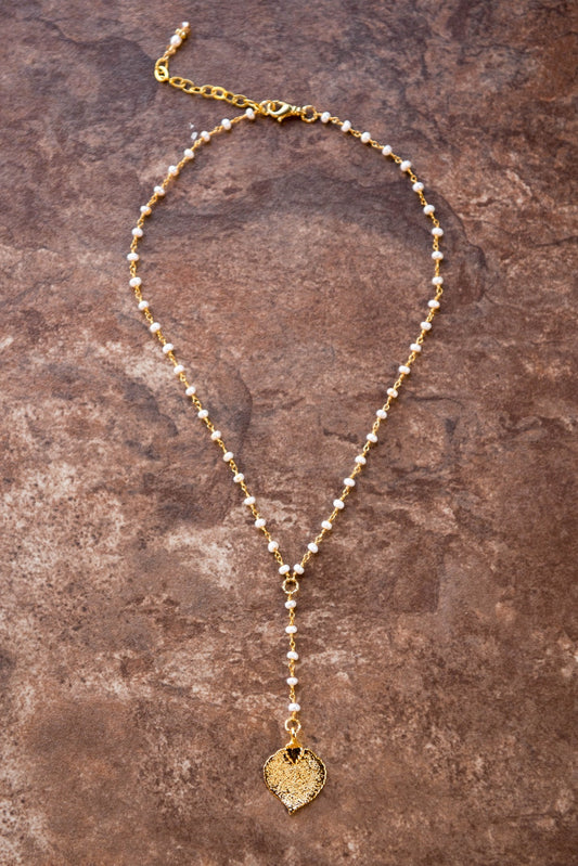 Pearls in gold chain: Fresh water pearls accent the dramatic Y style necklace with a small gold leaf