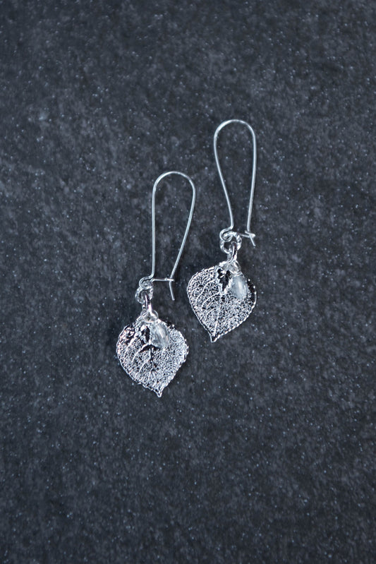 Silver earrings: Silver leaves combined with silver light weight medium length hoops. Finished with crystal dangles